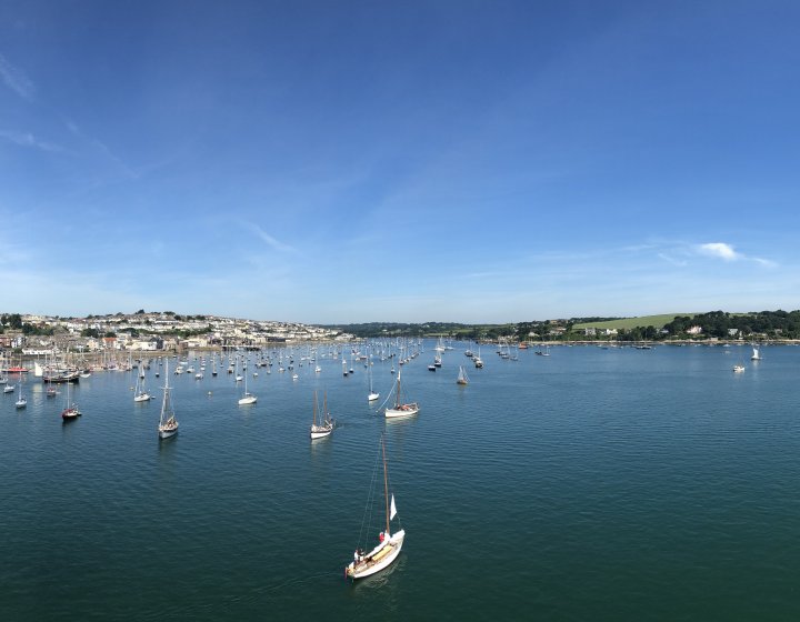 View of Falmouth from the water, coastline and boats.