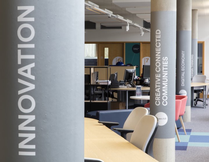 Building interior with innovation written on a grey pillar