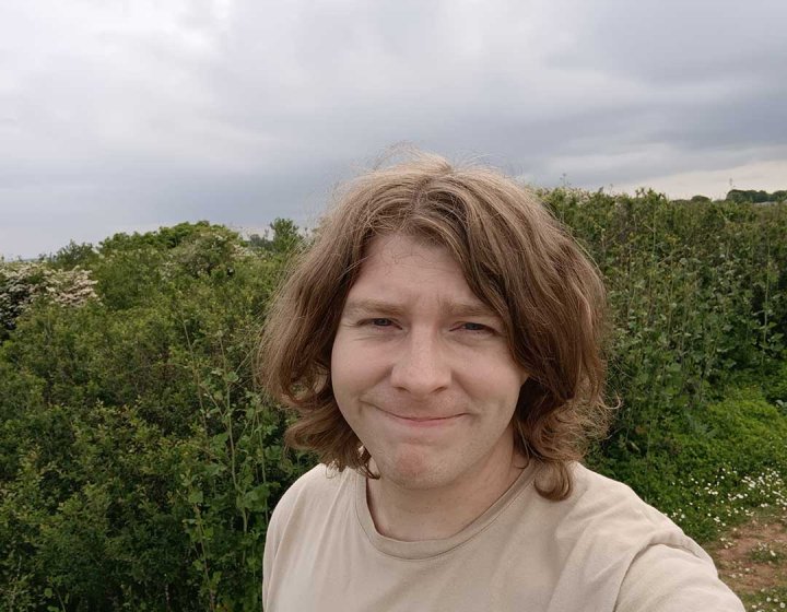 A selfie of comedy writing graduate Sean Phelan taken in a field