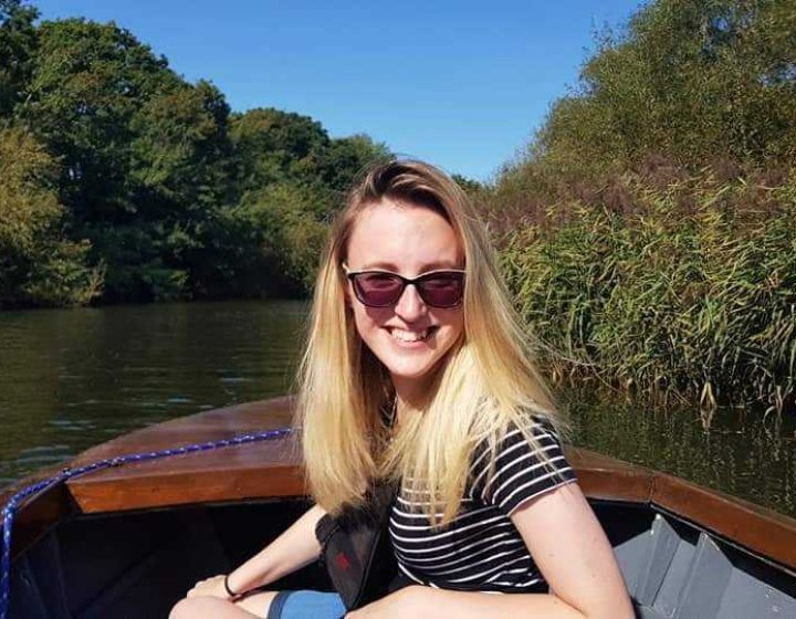 Student Lucy sat on a small boat on a lake
