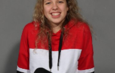 Anete Birzmale wearing a red and white jumper