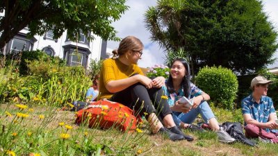 Students chatting in Woodlane Campus gardens.