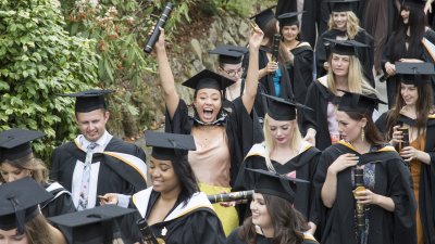 Falmouth University graduation 2019 – graduates walking through gardens in gowns and hats. 