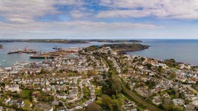 View from above of Falmouth, houses, coastline, sea and clouds.